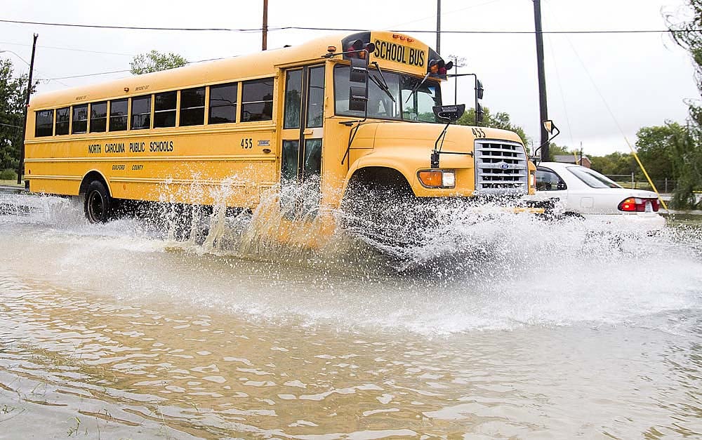 A Guilford County School bus navigates through a partially flooded ...