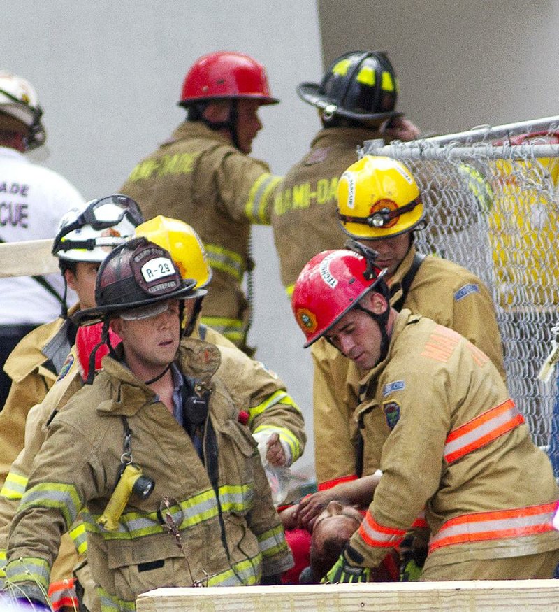 Garage Collapse Kills 2 Man Free After 12 Hours