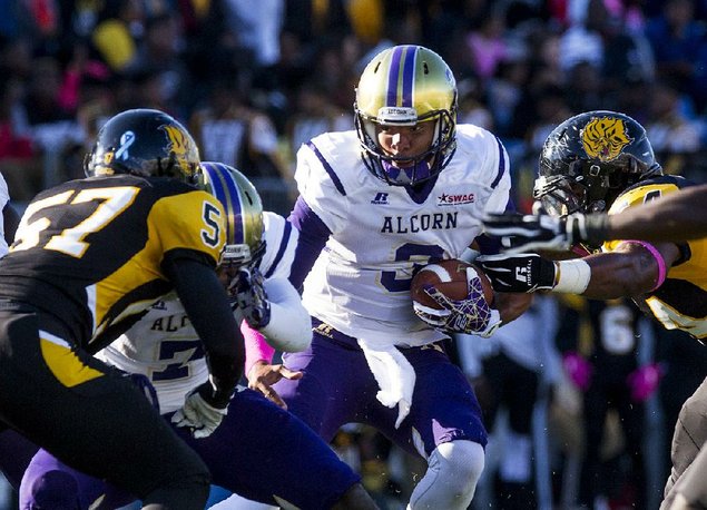 Alcorn State quarterback John Gibbs Jr. pushes through the UAPB defense during Saturday’s game at War Memorial Stadium in Little Rock. Gibbs ran for 3 touchdowns and passed for 2 as the Braves beat the Golden Lions 61-14. (Photo by Melissa Gerrits)