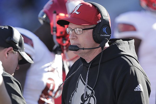 Louisville head coach Bobby Petrino talks to his team during a timeout during the second half of an NCAA college football game against Kentucky Saturday, Nov. 25, 2017, in Lexington, Ky. Louisville won the game 44-17. (AP Photo/David Stephenson)

