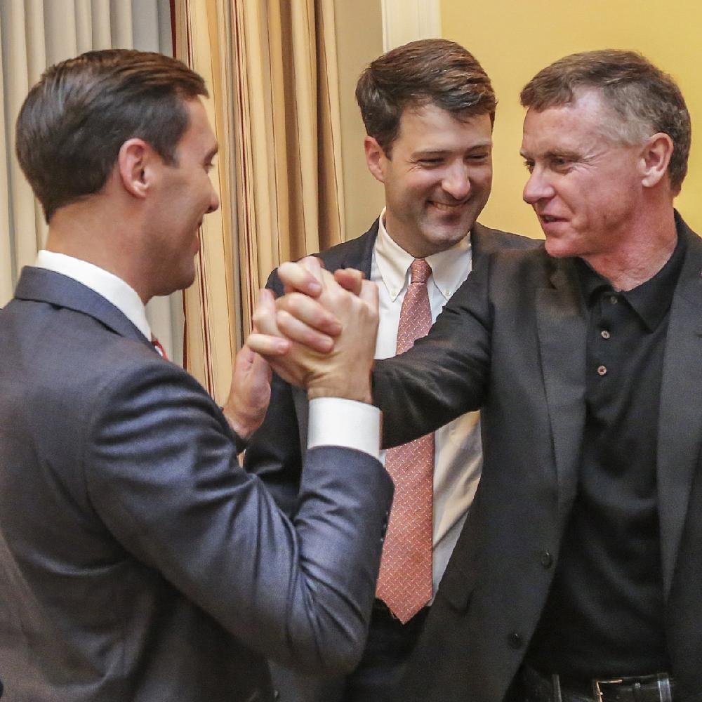 Nate Steel (left), legal counsel for Driving Arkansas Forward, celebrates the gambling proposal’s passage Tuesday night with Tony Holden (right) and Alex Gray.