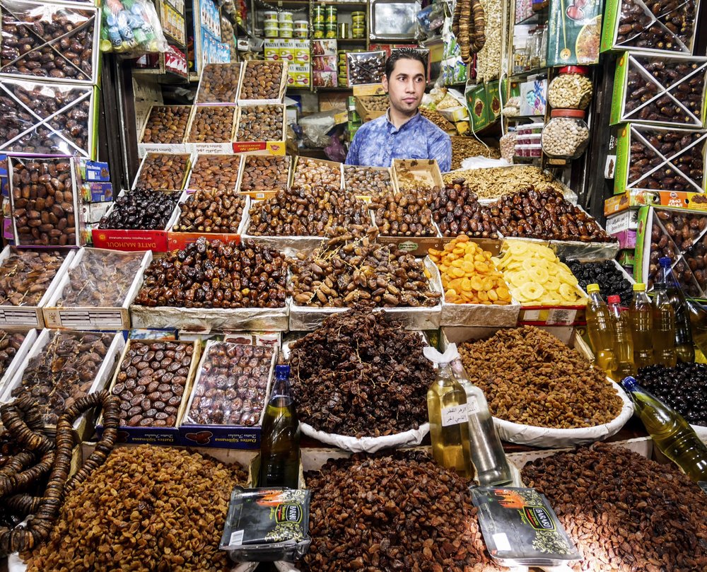 A man hawks dates and other dried fruits in one of the thousands of stalls in the souks of Fez. Photo by Bob Drogin via Los Angeles Times (TNS