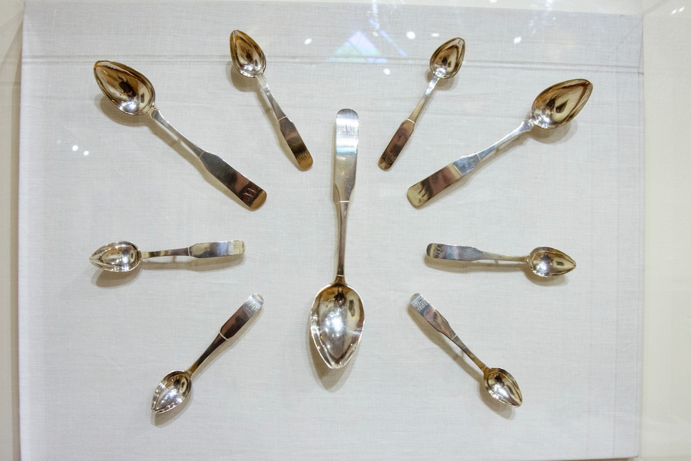 An assortment of silver from the early 19th Century hangs in the Study Gallery at the Historic Arkansas Museum. The pieces were arranged and mounted by Andy Zawacki, the museum's object conservator. (Arkansas Democrat-Gazette/CARY JENKINS) 