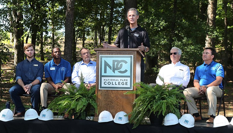 The Sentinel-Record/Richard Rasmussen ADDRESSES: National Park College President John Hogan speaks at a dedication for the school's first student dormitory on Wednesday. Seated, from left, are Harrison Felton, Student Government Association president, Jerry Thomas, Servitas representatives David Braden and Blair Tavenner, and NPC board President Forrest Spicher.