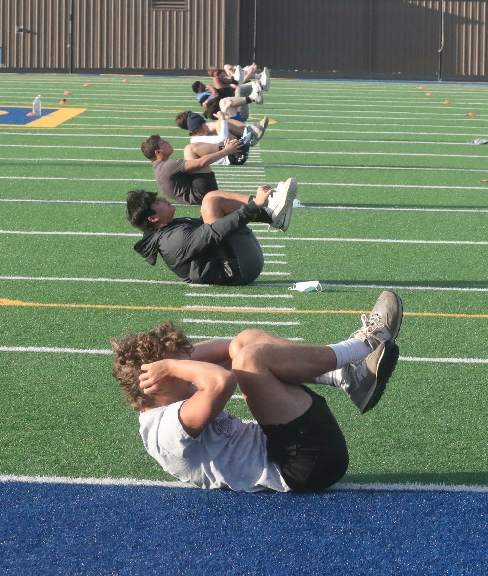 Lakeside High School football players go through workouts Monday morning at Chick Austin Field. The players were getting their first workout as a team since schools were closed in mid-March. - Photo by Richard Rasmussen of The Sentinel-Record