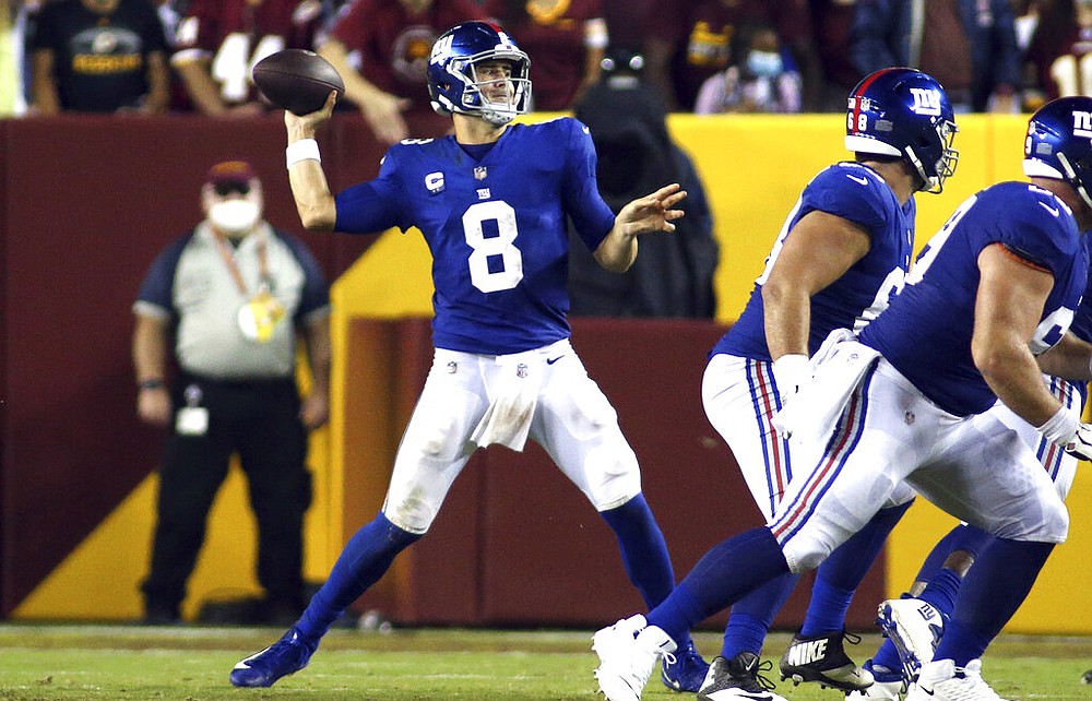 New York Giants quarterback Daniel Jones (8) runs downfield with the ball  during the first half of an NFL football game against the Washington  Football Team, Thursday, Sept. 16, 2021, in Landover