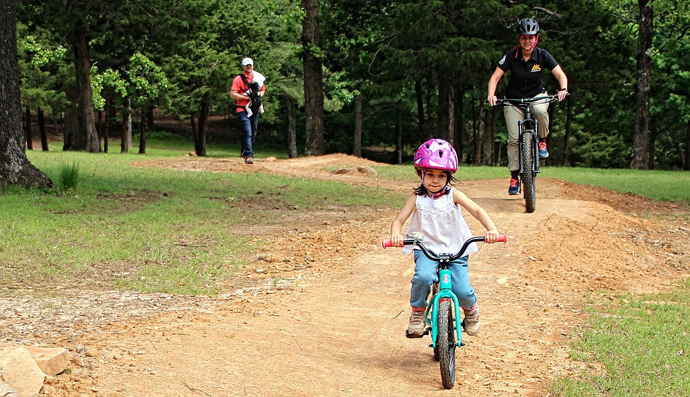 Suzanne Grobmeyer, executive director for the Arkansas Parks and Recreation Foundation, pursues her daughter Margaret with husband Andrew and son George following on a child-friendly path at Mount Nebo State Park.  (Special to the Democrat-Gazette/Bob Robinson)
