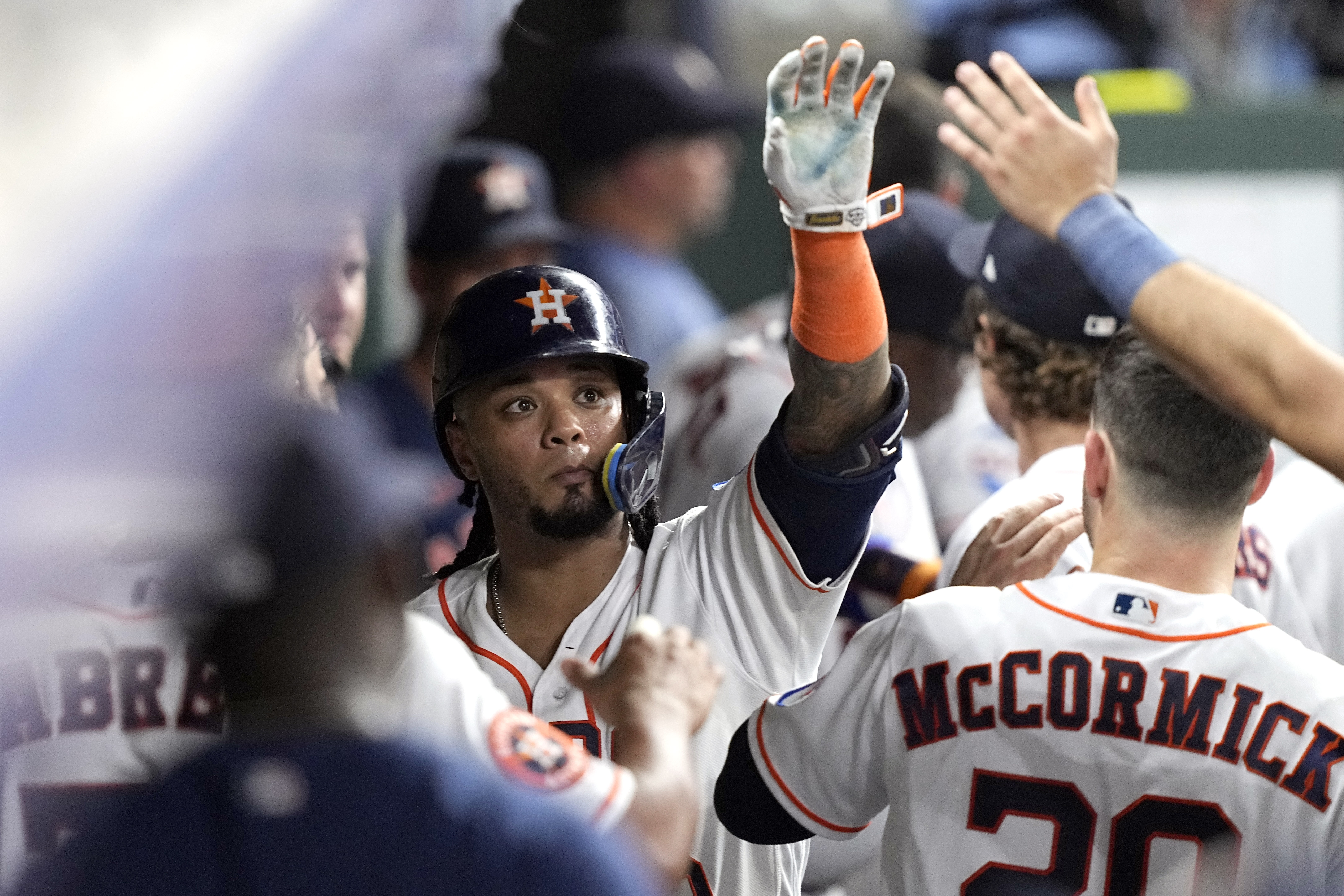 Houston Astros' Lance Berkman walks back to the dugout after